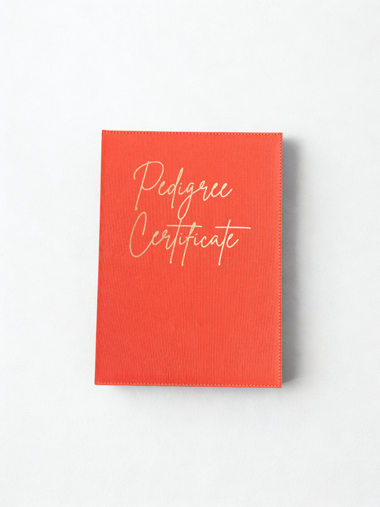 Red book titled 'Pedigree Certificate' on a white background