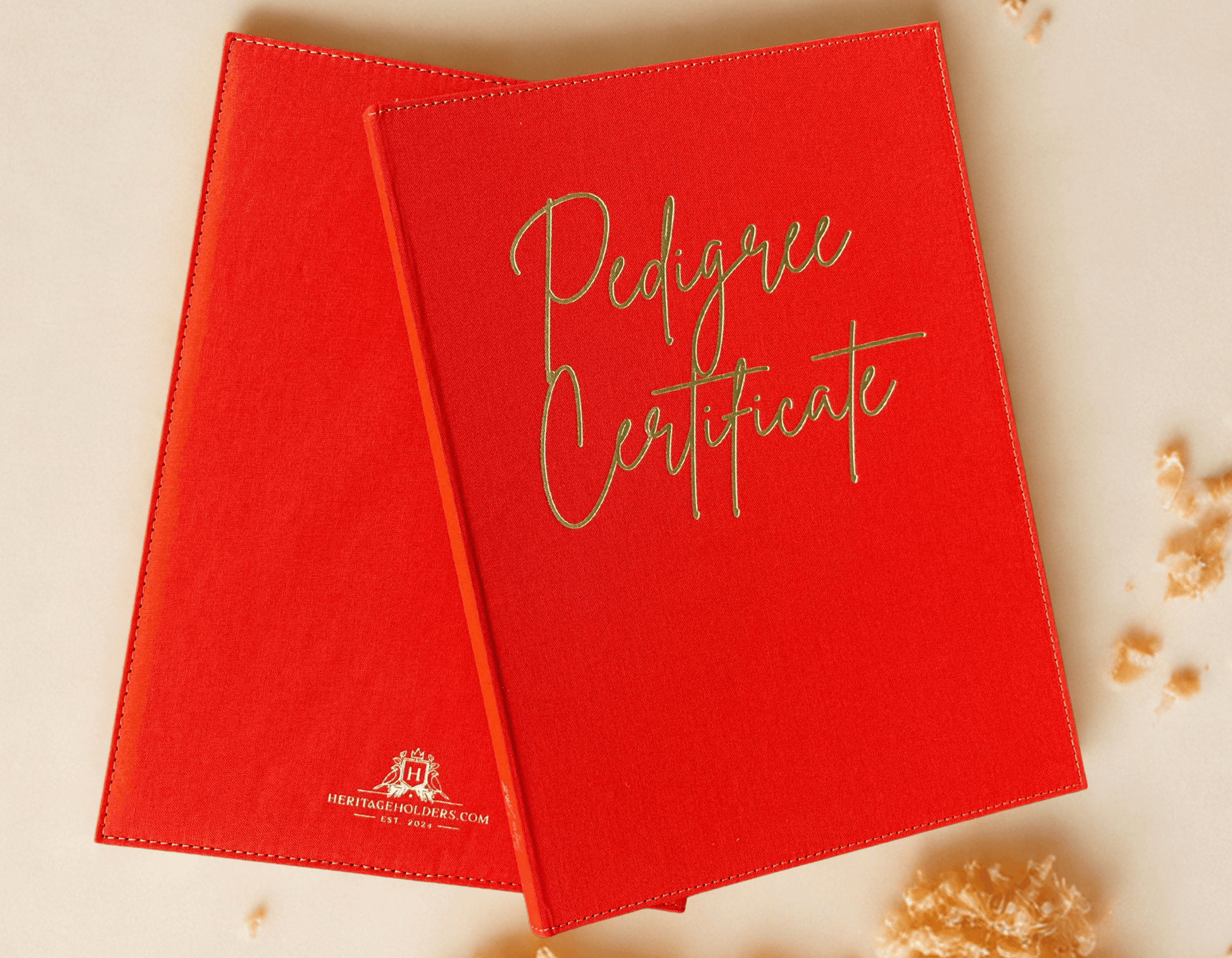 Two red 'Pedigree Certificate' books on a light background