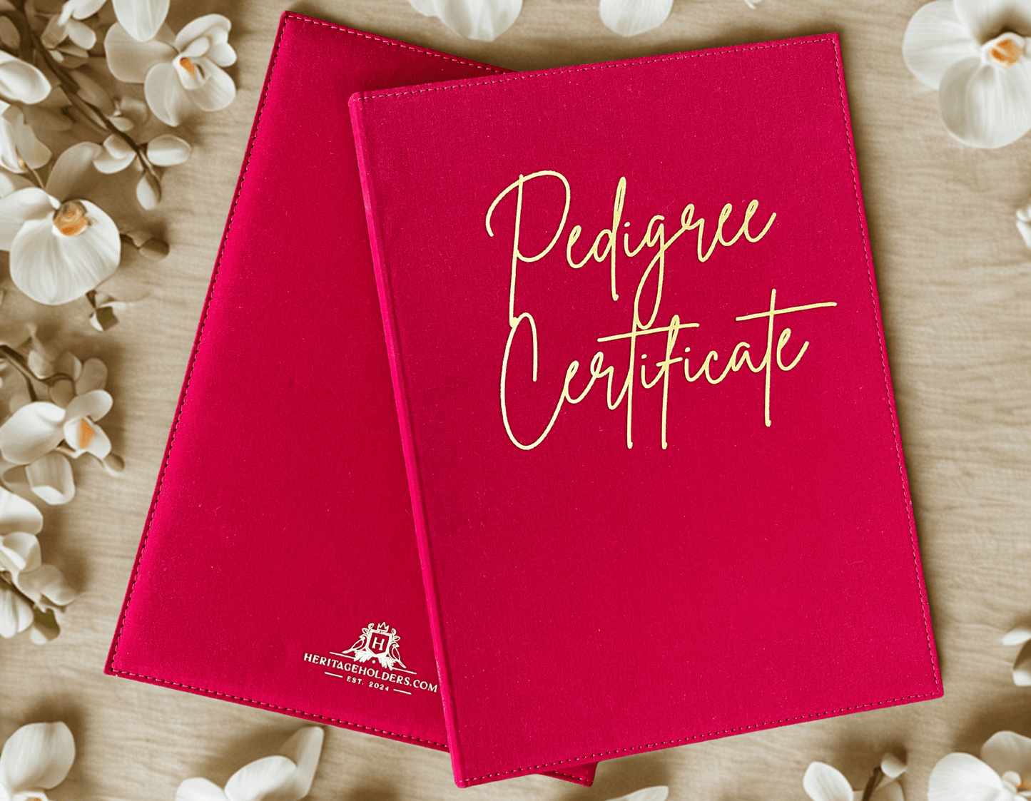 Red 'Pedigree Certificate' holder with white text on a wooden surface with flowers.