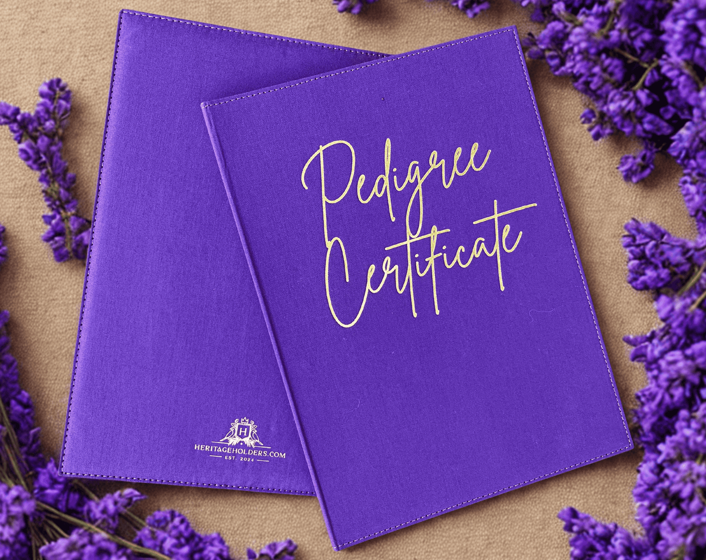 Two purple 'Pedigree Certificate' books with lavender flowers on a wooden surface