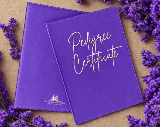 Two purple 'Pedigree Certificate' books with lavender flowers on a wooden surface