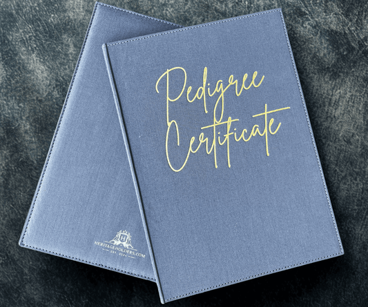 Two blue 'Pedigree Certificate' folders on a dark textured surface